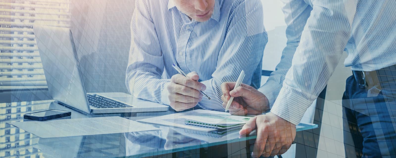 Two colleagues reviewing a quote together at a desk